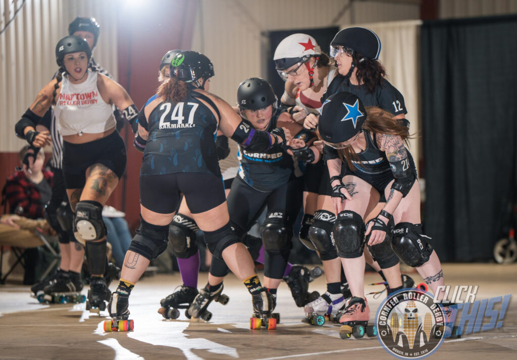 Three Cornfed blockers and the Cornfed jammer surrounds the Naptown jammer during the January 21, 2023 game.